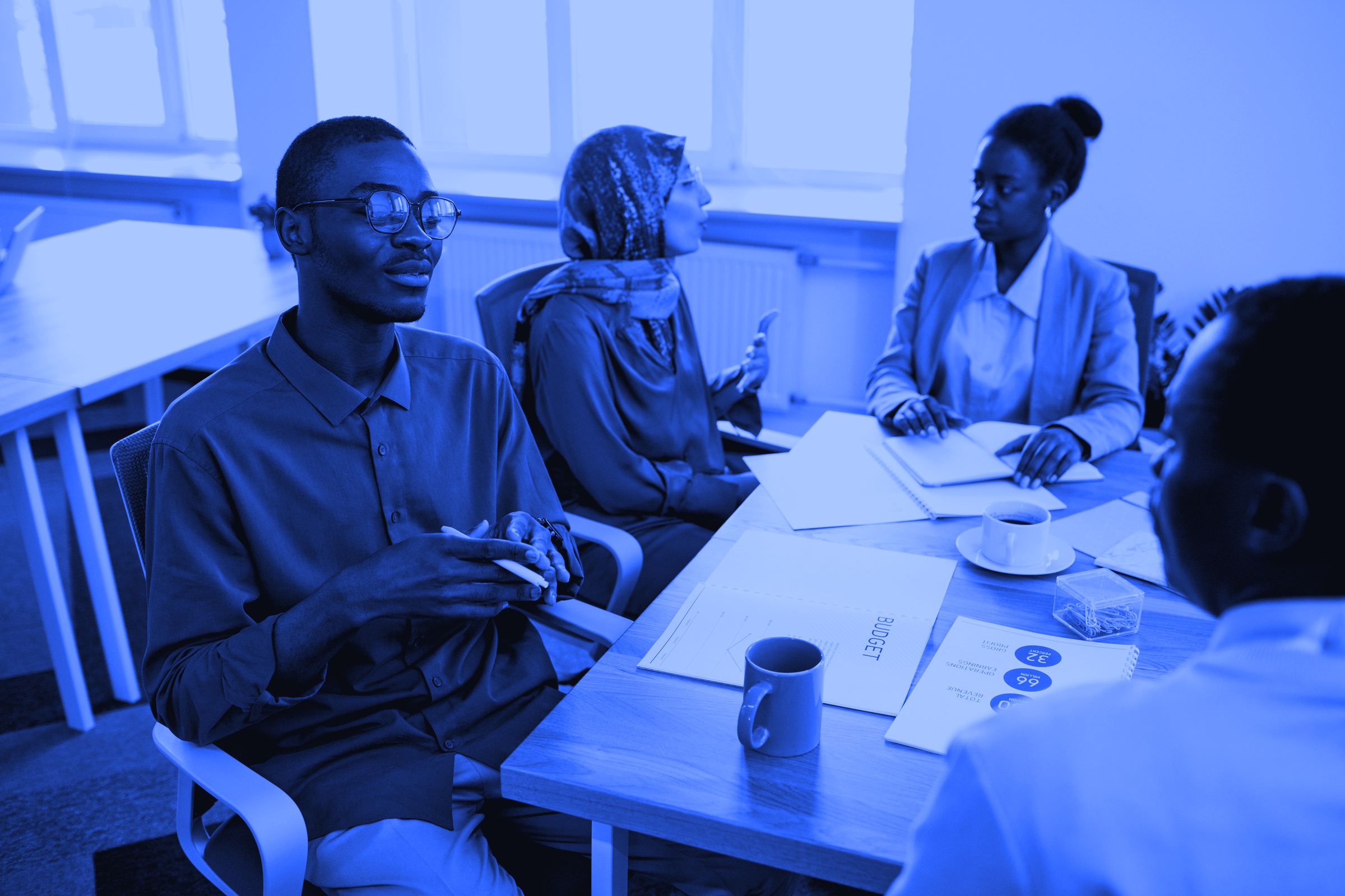 Delegates in discussion around a meeting table